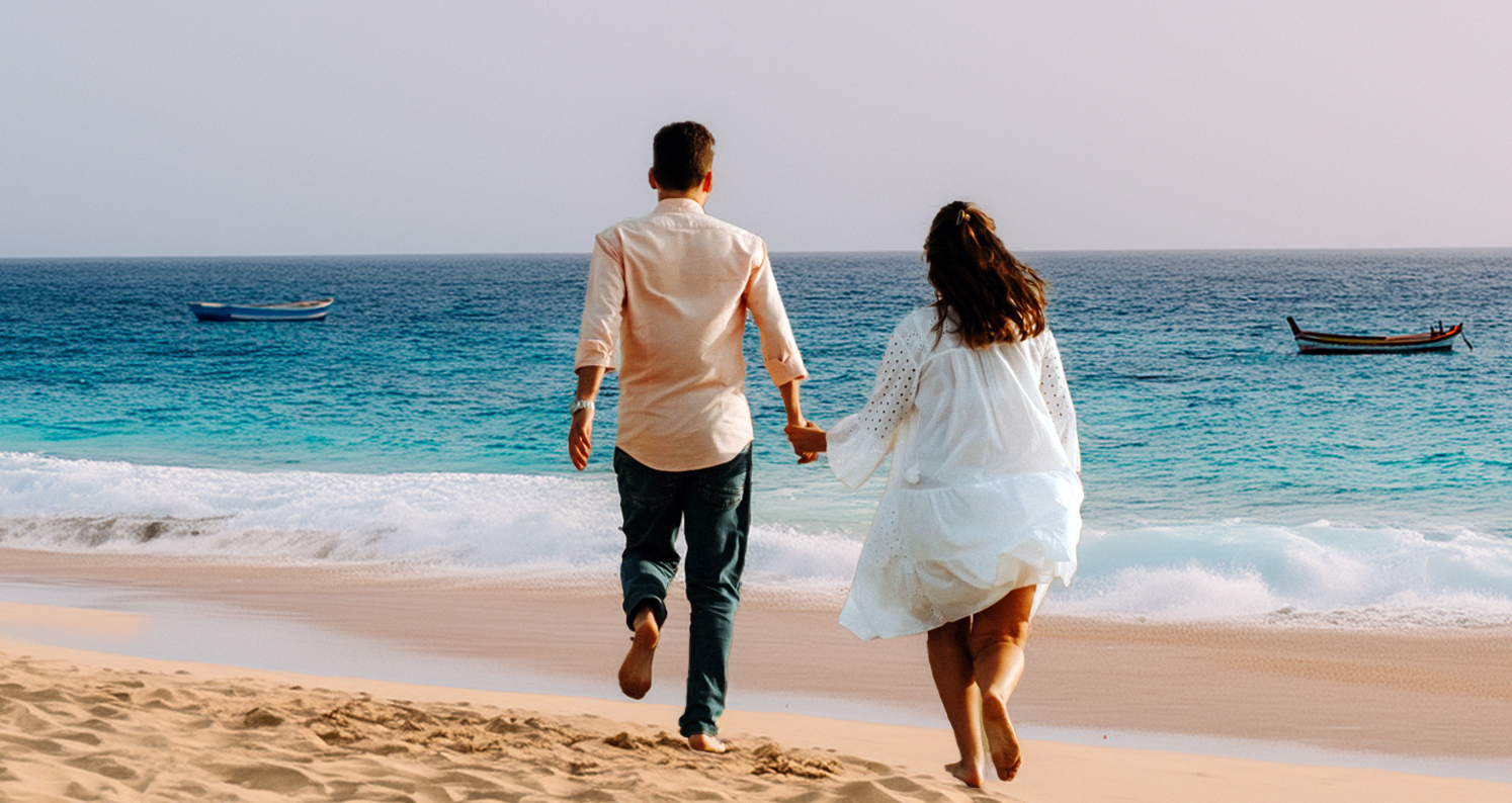 Couple walking towards the sea on a beach in Cape Verde