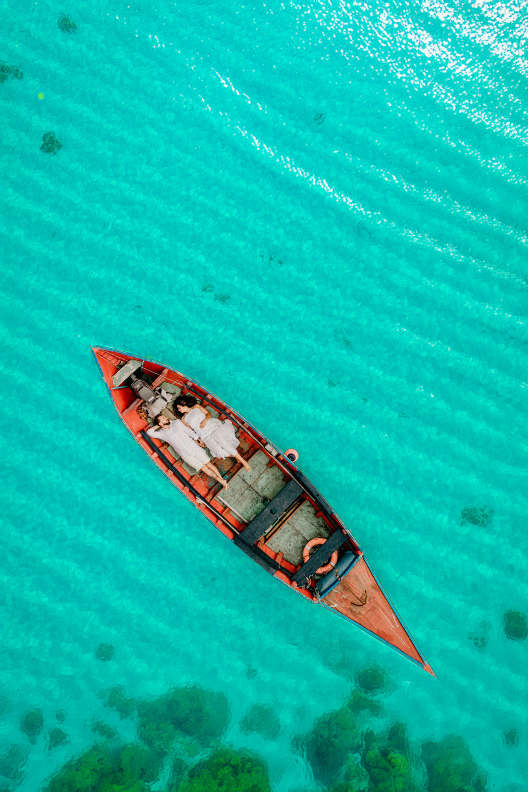 Wedding couple in a boat on turquoise water off Sal Island
