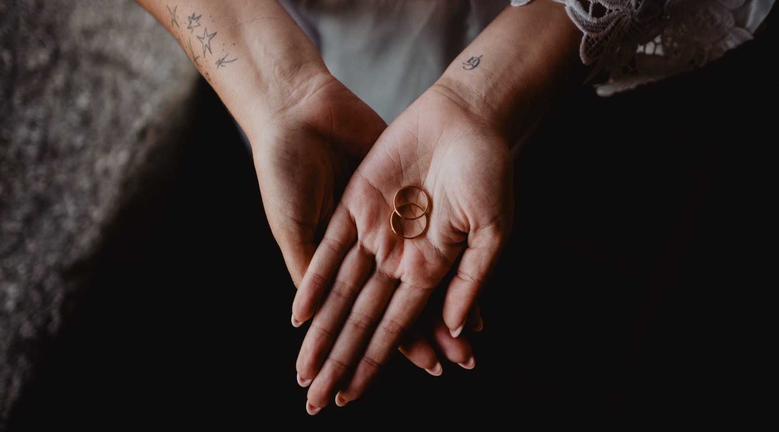 Wedding rings displayed in a couple’s hands